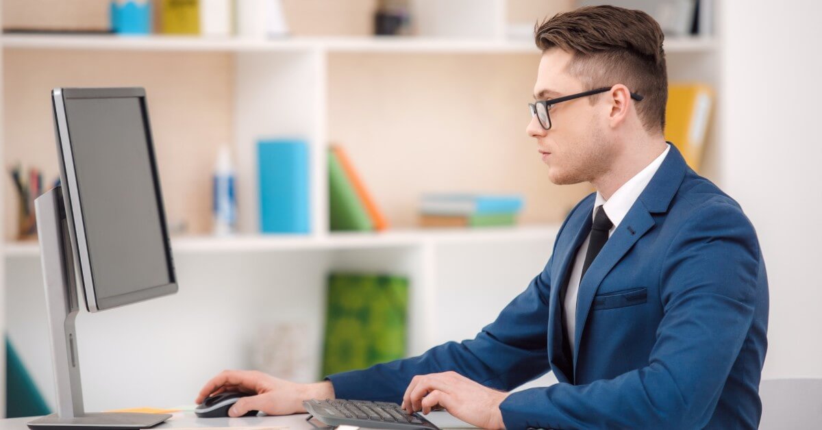 man writing on laptop